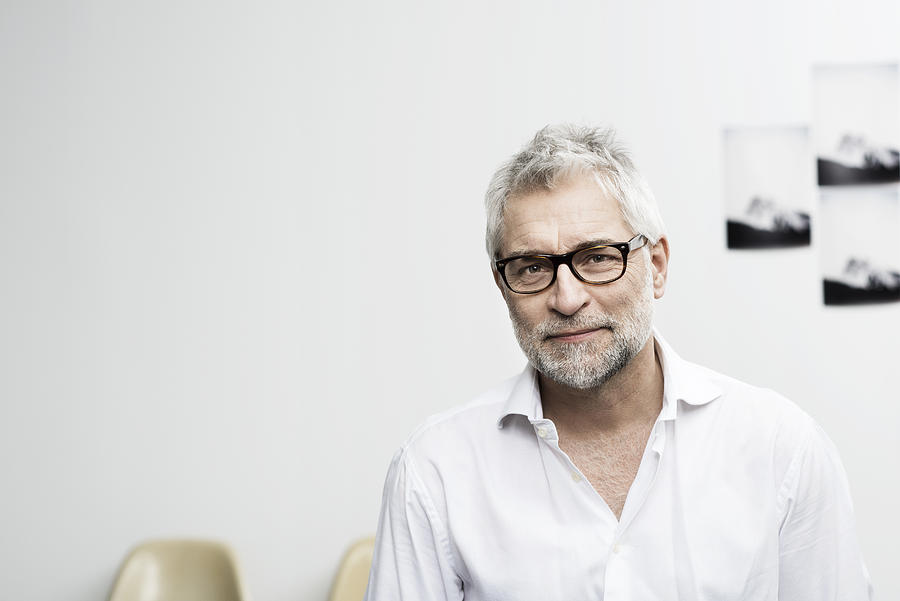 Portrait of creative grey haired man with glasses Photograph by Robin Skjoldborg