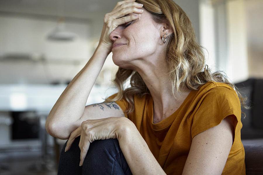 Portrait of crying woman with hands on her face while sitting indoors Photograph by Mindful Media Portrait of crying woman with hands on her face while sitting indoors Photograph by Mindful Media