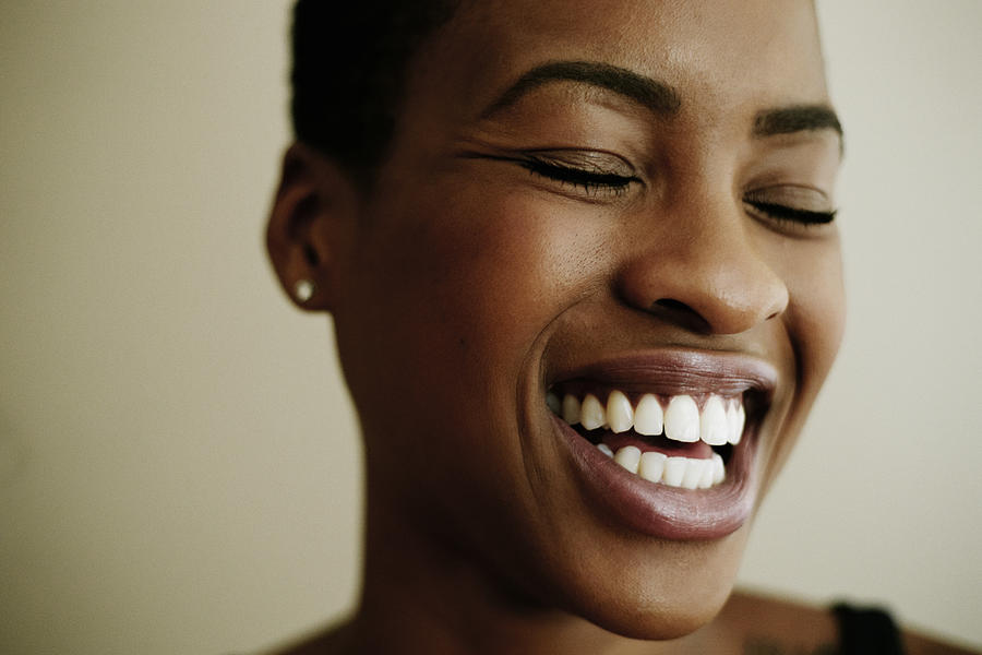 Portrait of face of laughing Black woman Photograph by Peathegee Inc