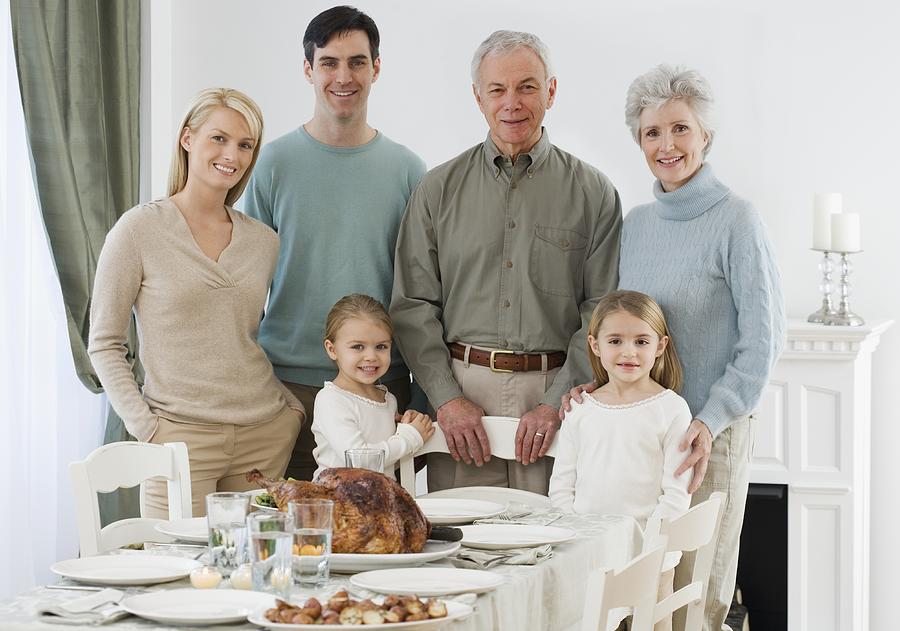 Portrait of family at Thanksgiving table Photograph by Tetra Images