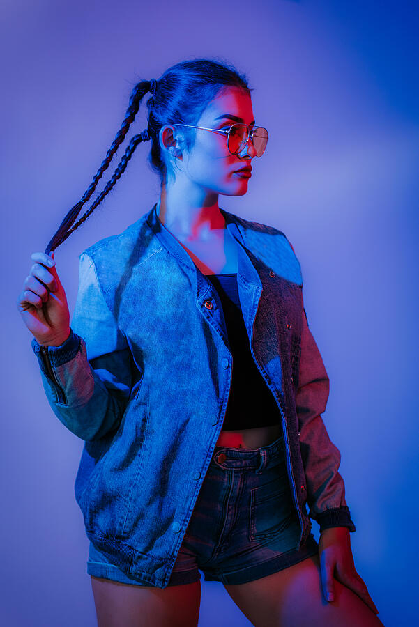 Portrait of female high fashion model in neon light Photograph by MilanRist