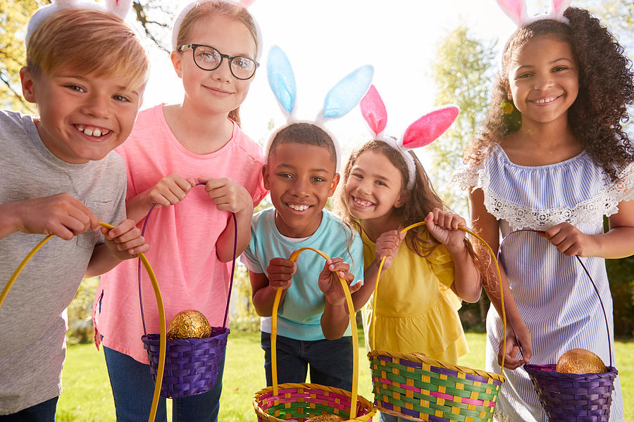 Portrait Of Five Children Wearing Bunny Ears On Easter Egg Hunt In Garden Photograph by Monkeybusinessimages