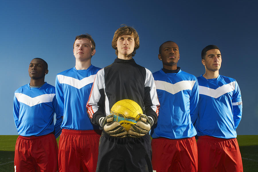 Portrait of football team, goalkeeper holding ball Photograph by Peter Muller