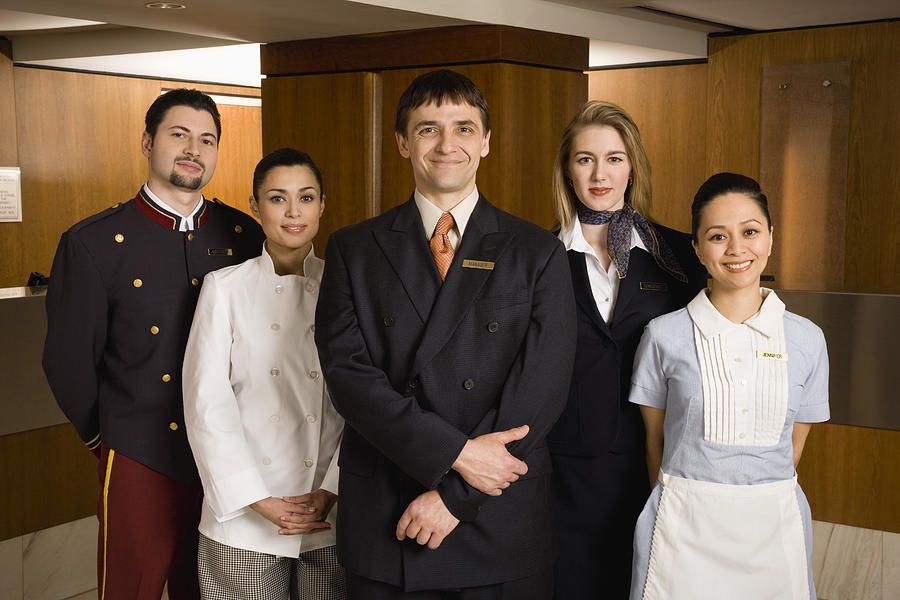 Portrait of friendly hotel staff Photograph by Jupiterimages