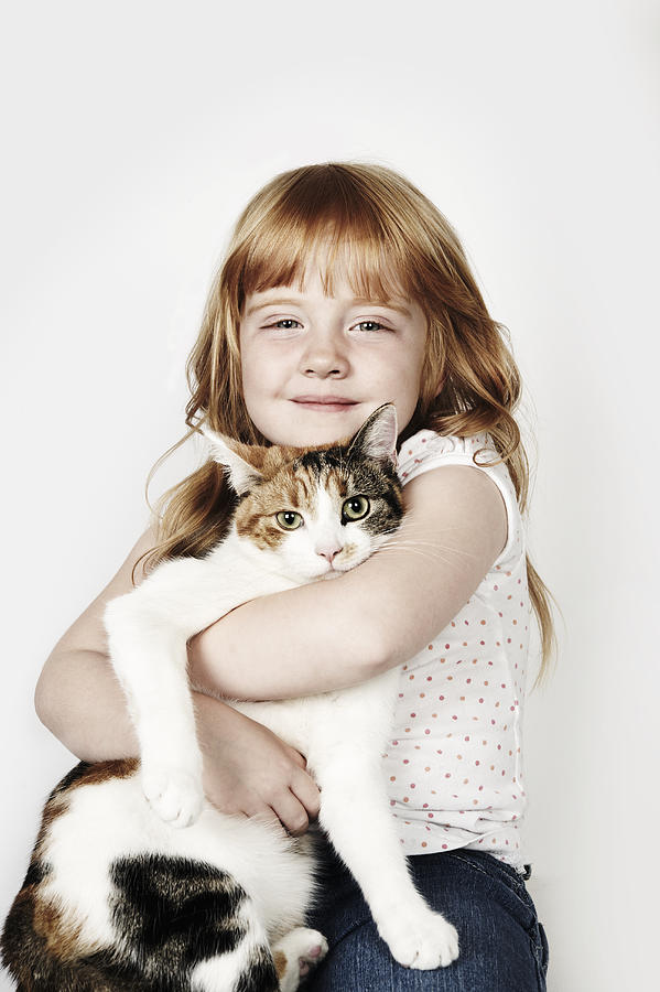 Portrait of girl hugging her pet cat Photograph by Flashpop