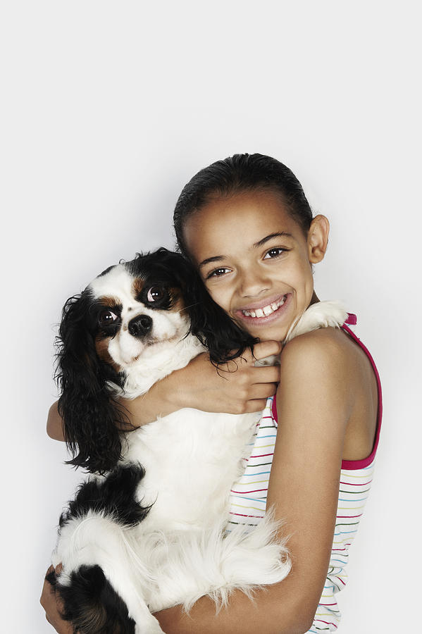 Portrait of girl hugging her pet dog Photograph by Flashpop