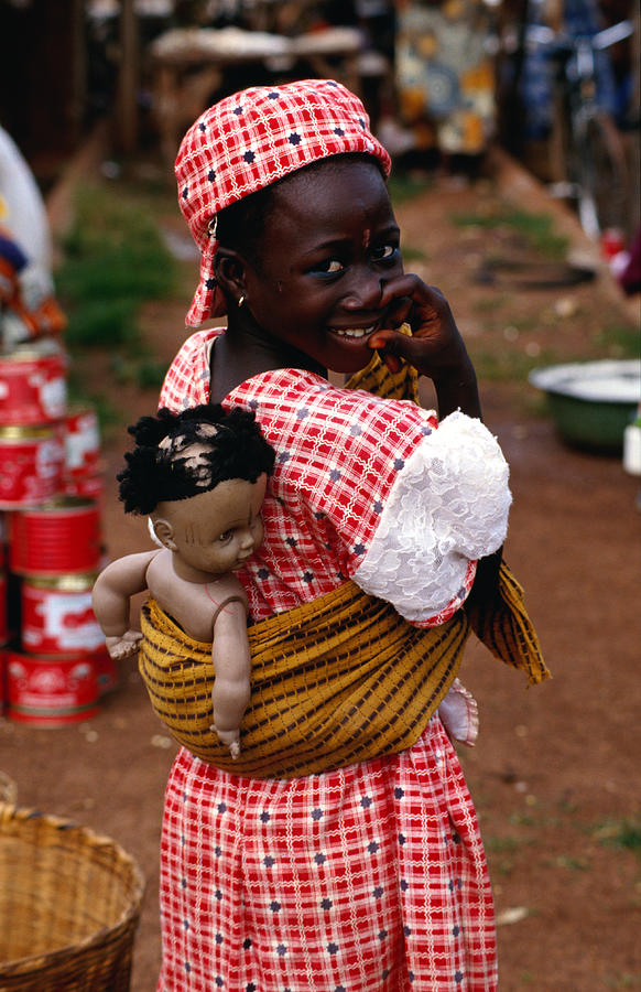 Portrait of girl with doll on her back, Ketao. Photograph by Craig Pershouse