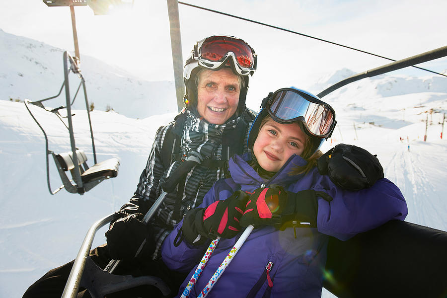 Portrait of grandmother and granddaughter on ski lift, Les Arcs, Haute-Savoie, France Photograph by Adie Bush