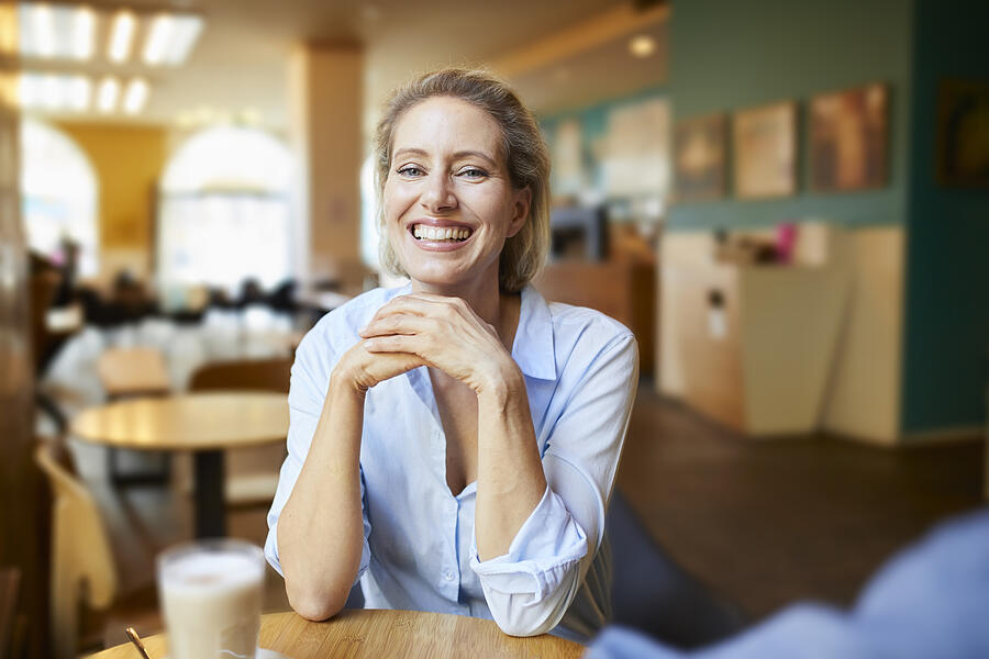 Portrait of happy woman in a cafe Photograph by Westend61