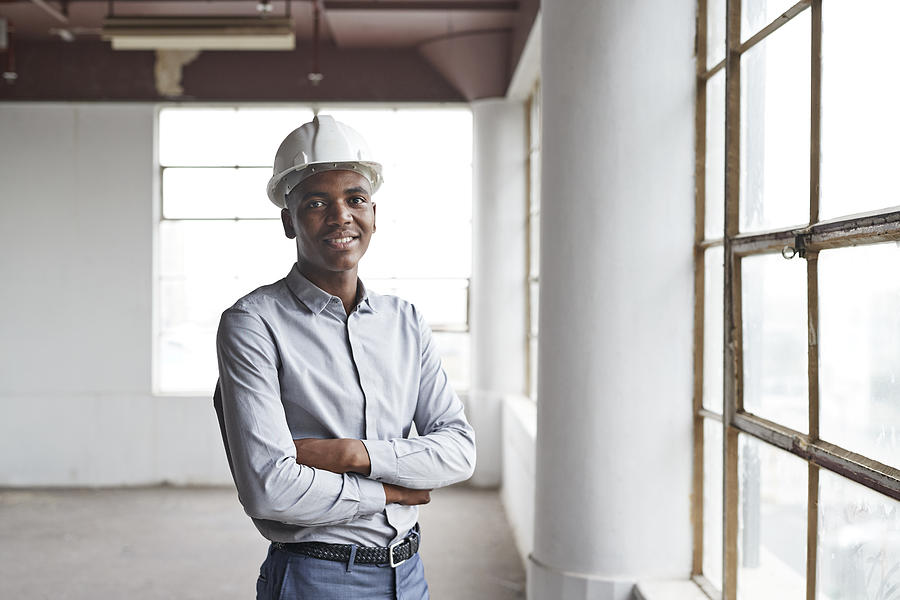 Portrait of male engineer standing in new office Photograph by Klaus Vedfelt