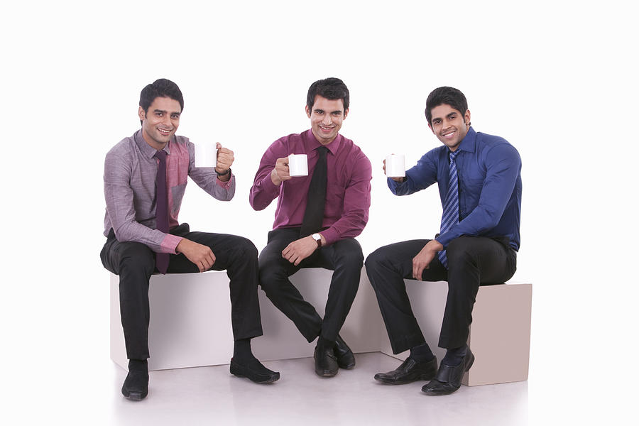 Portrait of male executives with mugs of tea Photograph by Sudipta Halder