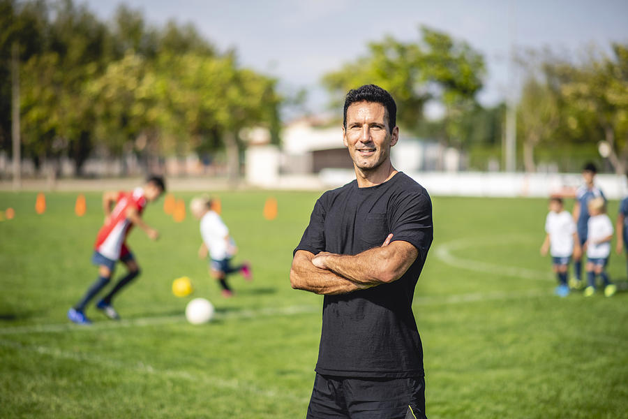 Portrait of Male Footballer Coaching Mixed Age Players Photograph by AzmanJaka