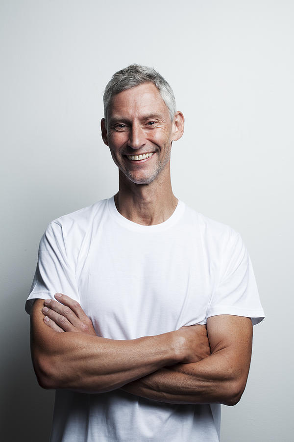 Portrait of man in white t-shirt in his 50s Photograph by Allison Michael Orenstein