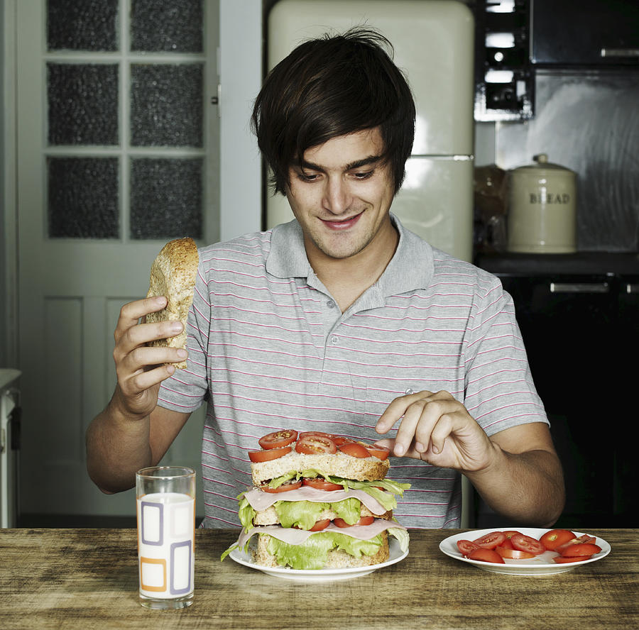 Portrait of man making a sandwich Photograph by Flashpop