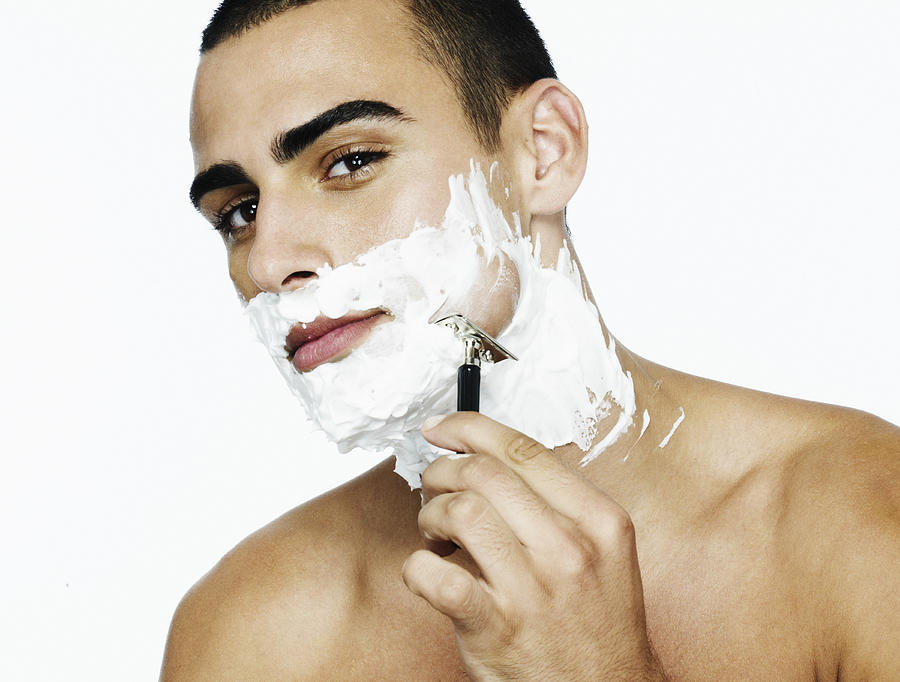 Portrait of man shaving his face Photograph by Flashpop