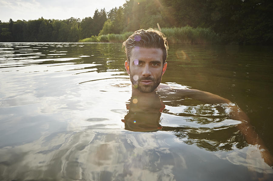 Portrait of man swimming in lake Photograph by Uwe Krejci