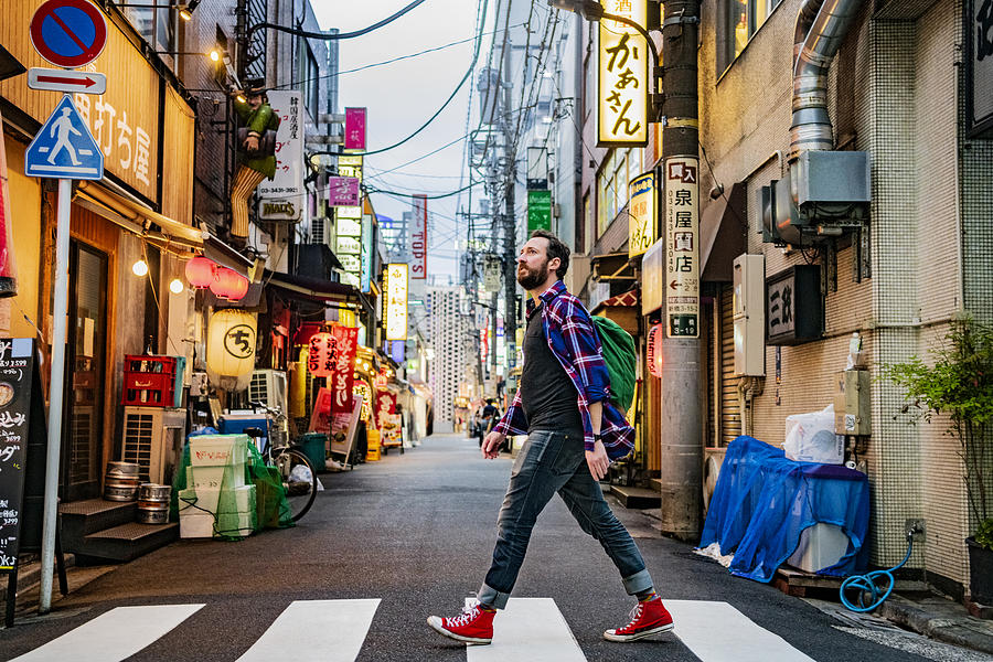 Portrait of man walking on zebra crossing on Tokyo street Photograph by JohnnyGreig Portrait of man walking on zebra crossing on Tokyo street Photograph by JohnnyGreig