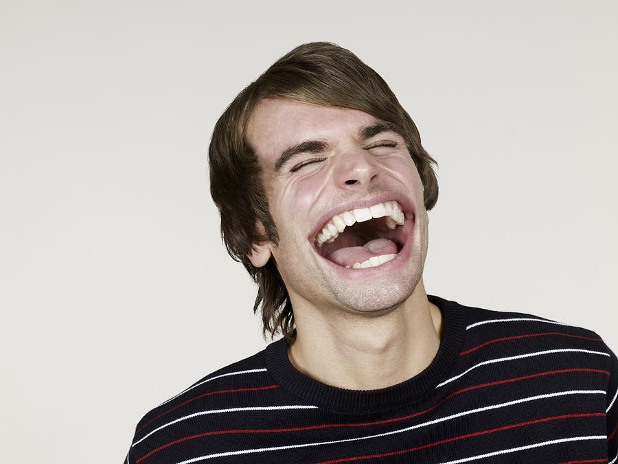 Portrait of man with big mouth laughing Photograph by Flashpop