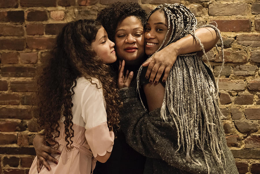 Portrait of mature African-American mother with daughters Photograph by Martinedoucet