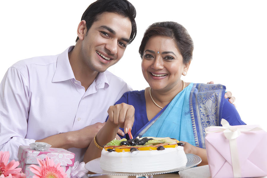 Portrait of mother and son with birthday cake Photograph by IndiaPix/IndiaPicture