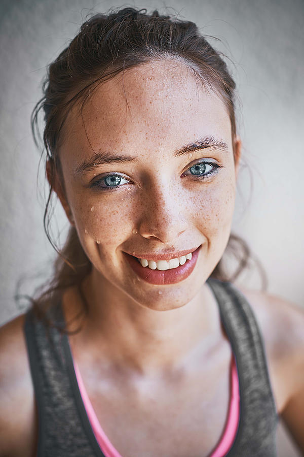 Portrait of pretty, athletic young woman smiling Photograph by RapidEye