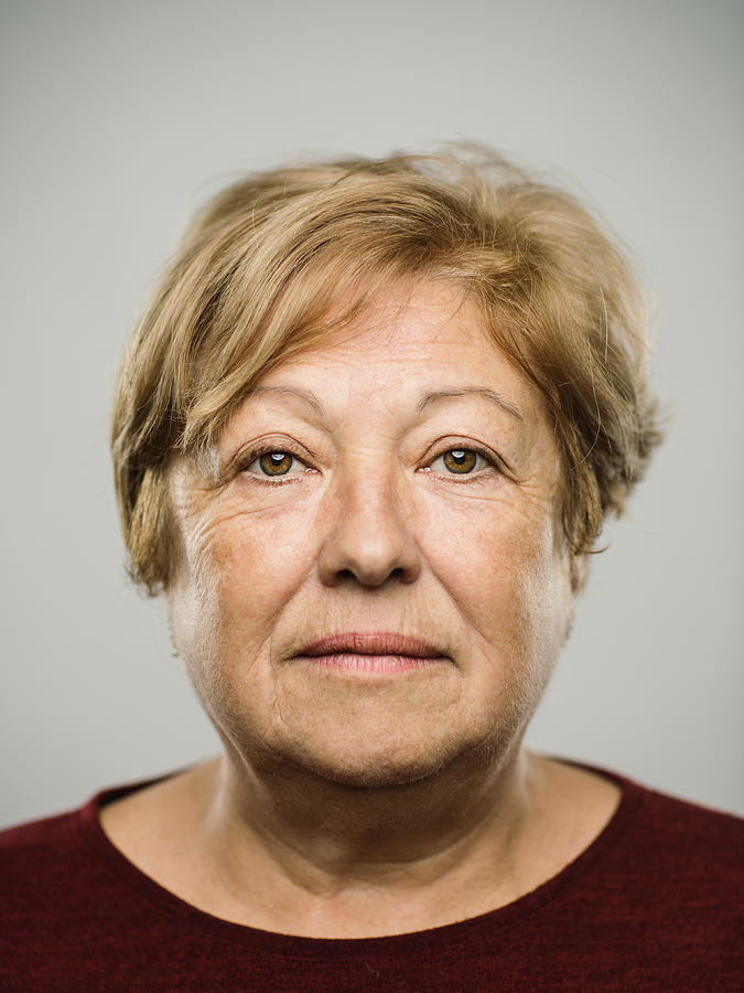 Portrait of real caucasian mature adult woman with blank expression Photograph by SensorSpot