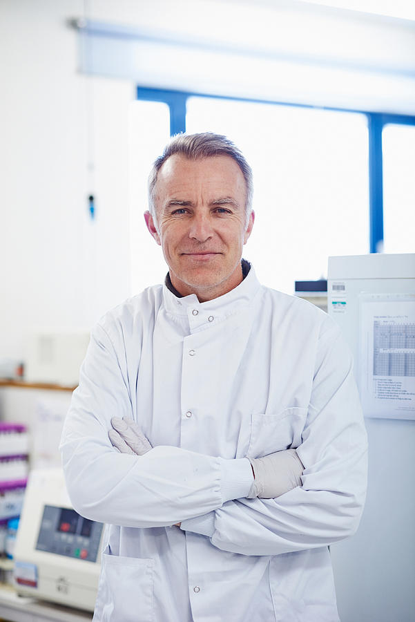 Portrait of researcher standing in lab wearing lab coat Photograph by Phil Fisk