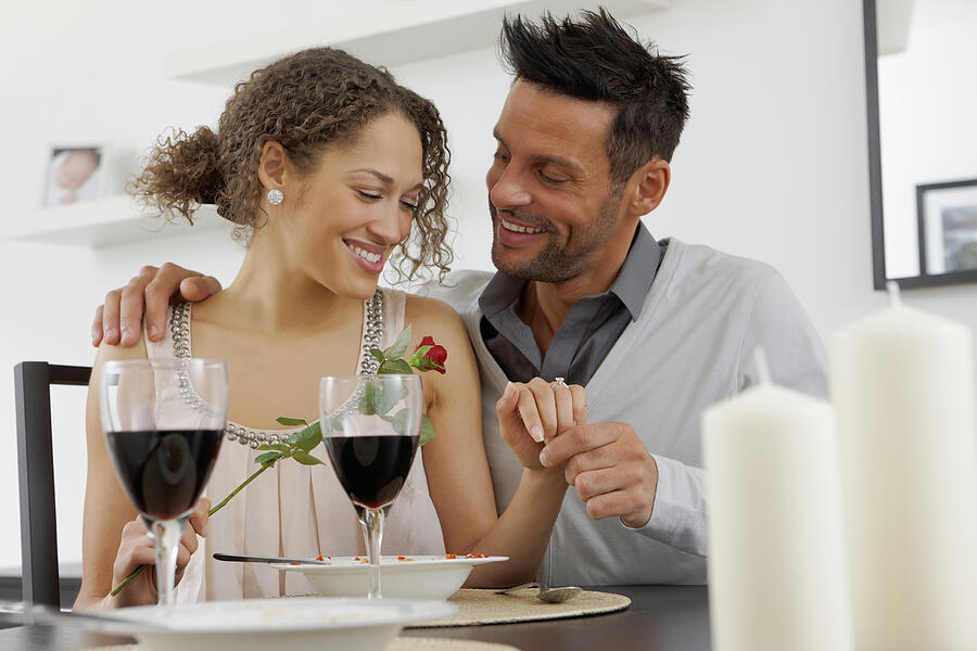Portrait of romantic young couple at dinning table Photograph by Dmp