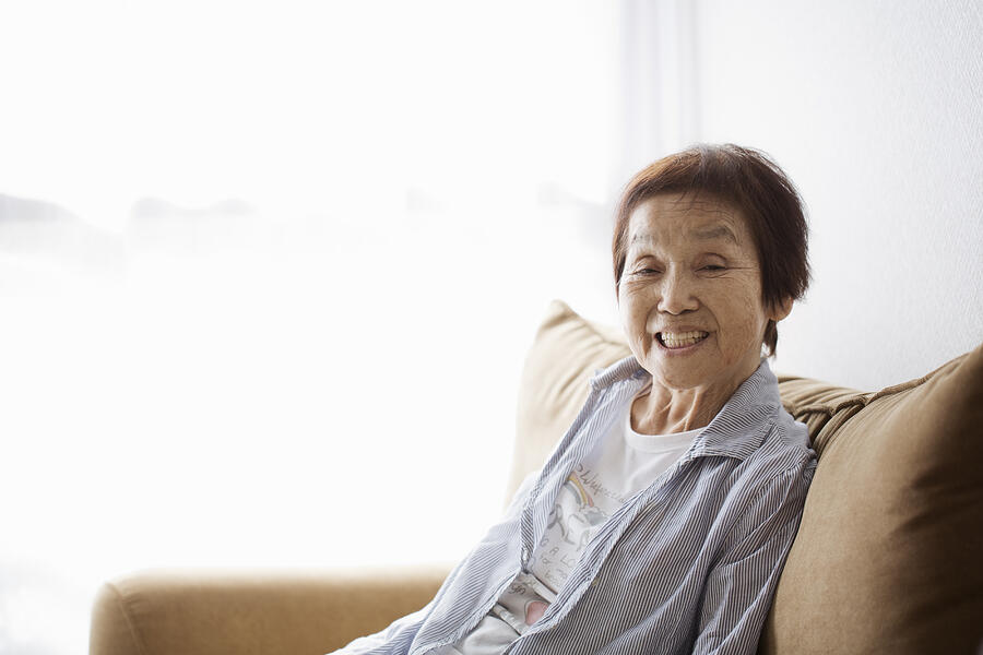 Portrait Of Senior Woman Sitting On The Sofa Photograph by Kohei Hara