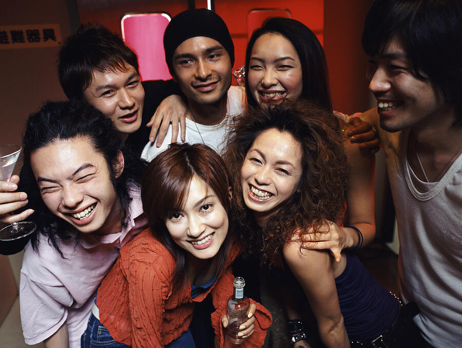 Portrait of Seven People Having Fun in a Bar Photograph by Digital Vision.
