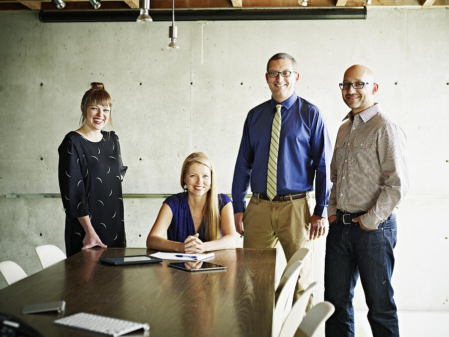 Portrait of smiling businessmen and businesswomen Photograph by Thomas Barwick