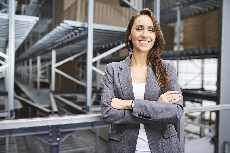 Portrait of smiling businesswoman in a factory Photograph by Westend61
