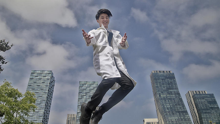 Portrait of smiling doctor jumping Photograph by Runstudio
