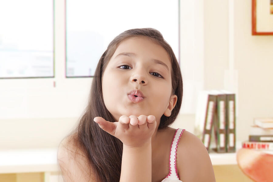 Portrait of smiling girl Blowing kisses Photograph by IndiaPix/IndiaPicture