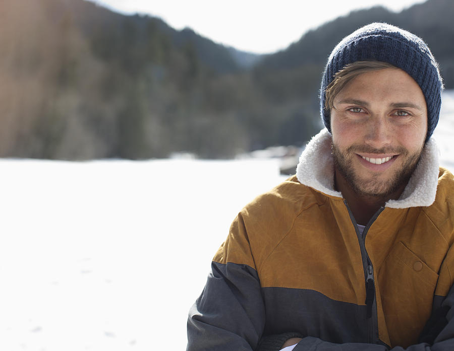 Portrait of smiling man in snow Photograph by Caia Image