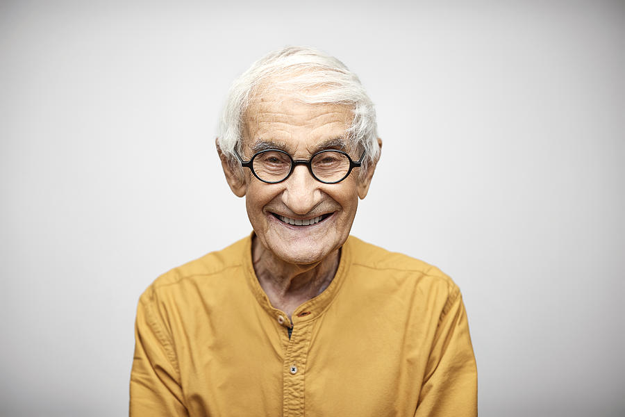 Portrait of smiling senior man having white hair Photograph by Morsa Images