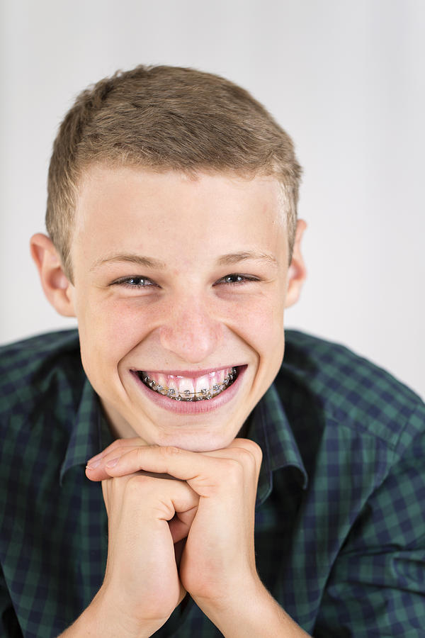 Portrait of smiling teenage boy with braces Photograph by Westend61