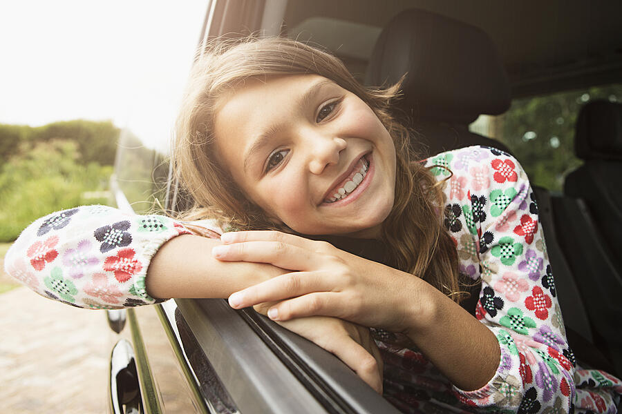 Portrait of smiling teenage girl (13-15) in car Photograph by Tomas Rodriguez
