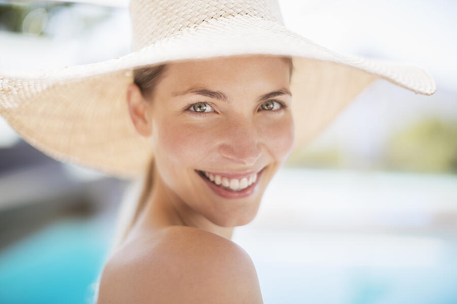 Portrait of smiling woman in sun hat Photograph by Tom Merton