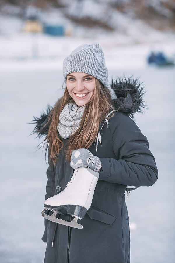 Portrait of smiling woman standing with ice skate Photograph by Vasily Pindyurin