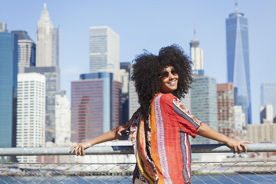 Portrait of smiling woman with Manhattan skyline Photograph by Compassionate Eye Foundation