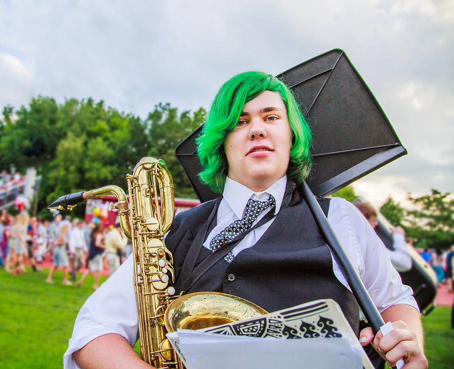Portrait of teenage boy holding saxophone and music stand Photograph by Sue Barr