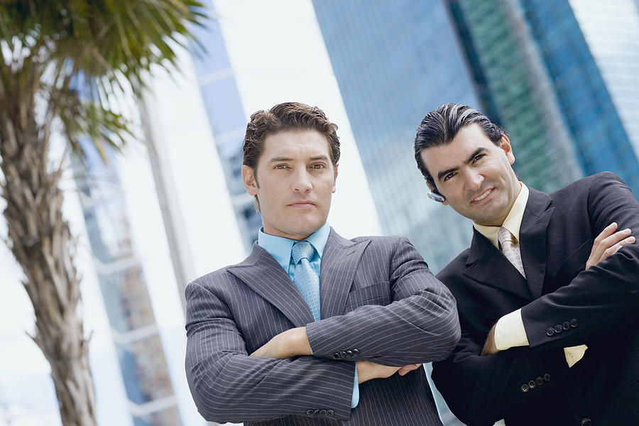 Portrait of two businessmen standing with their arms crossed Photograph by Glowimages