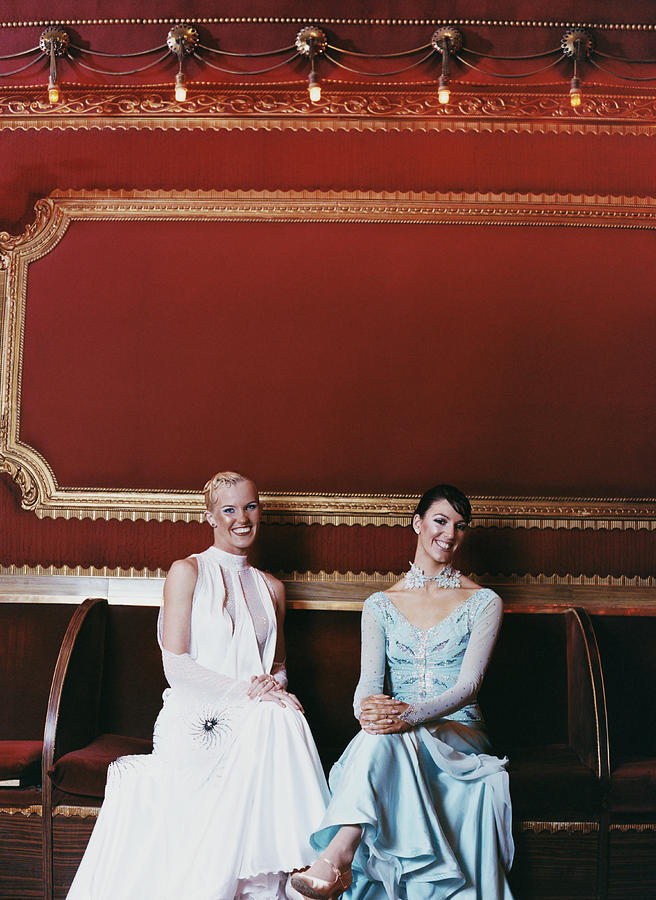 Portrait of Two Female Ballroom Dancers Sitting on a Bench Photograph by Digital Vision.
