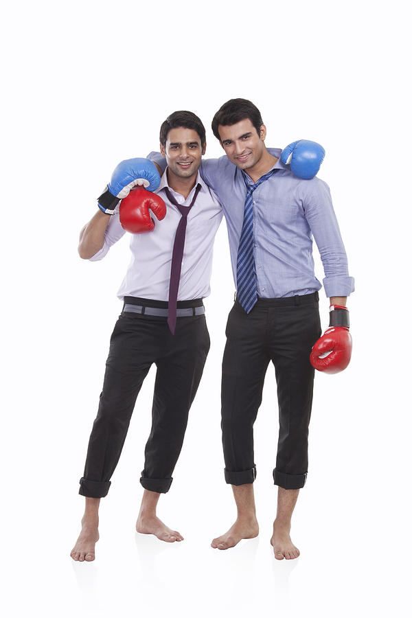 Portrait of two male executives with boxing gloves Photograph by IndiaPix/IndiaPicture
