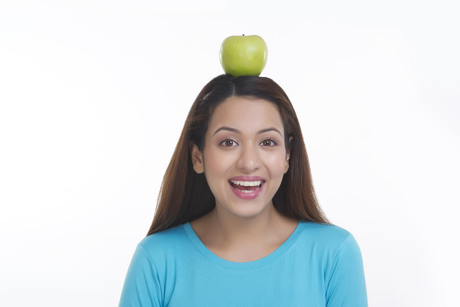 Portrait of woman balancing apple on head Photograph by Sudipta Halder