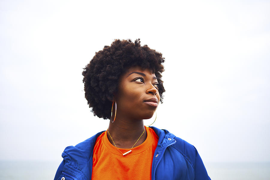 Portrait Of Woman Looking Off Camera With Colourful Clothing Photograph by Justin Lambert