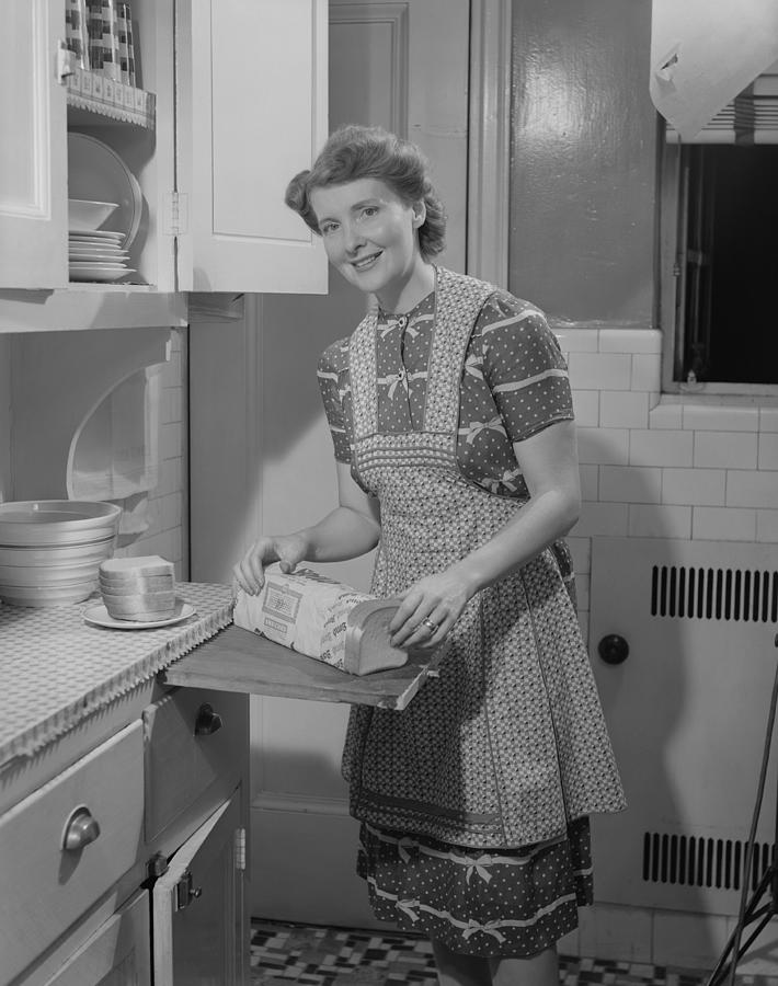 Portrait of woman preparing breakfast in kitchen Photograph by George Marks
