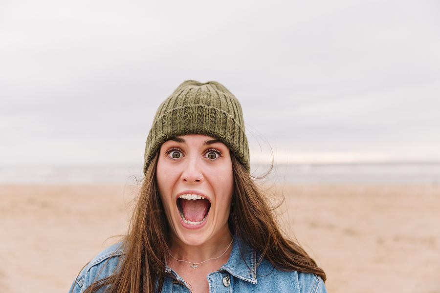 Portrait of woman pulling funny face on the beach Photograph by Westend61