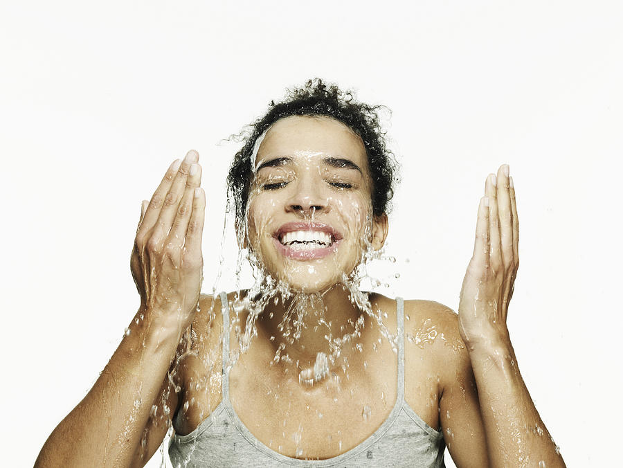 Portrait of woman splashing her face with water Photograph by Flashpop